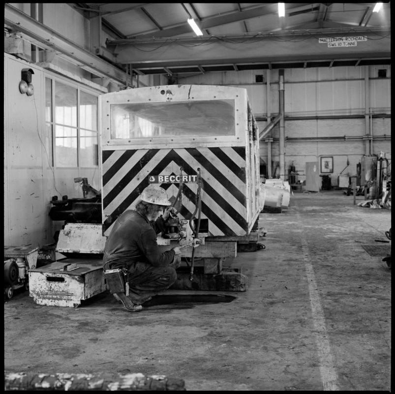 Black and white film negative showing maintenance work being carried out on a manriding train, Betws Mine.  &#039;Betws&#039; is transcribed from original negative bag.