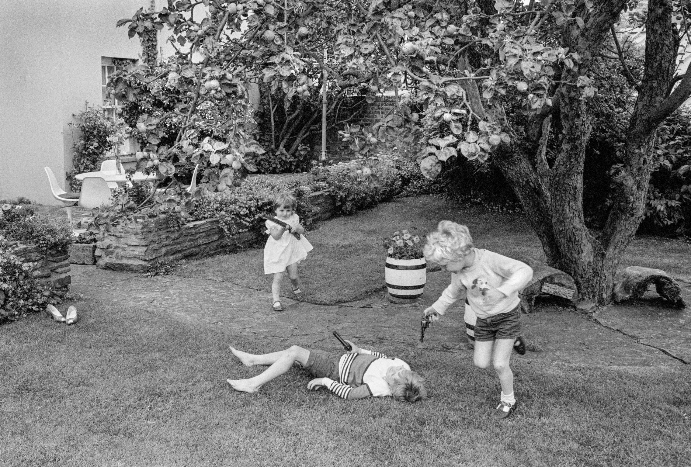 Children playing violence in back garden. Monmouth, Wales