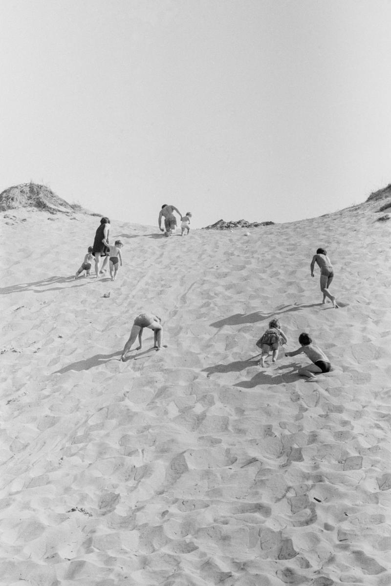 GB. WALES. Rhossili. Family climbing the dunes. 1971.