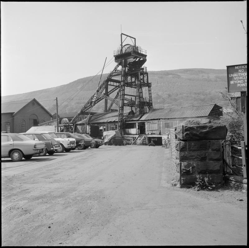 Black and white film negative showing the downcast headgear and Deep Duffryn Colliery carpark, 19 May 1977.  &#039;Deep Duffryn 19/5/77&#039; is transcribed from original negative bag.