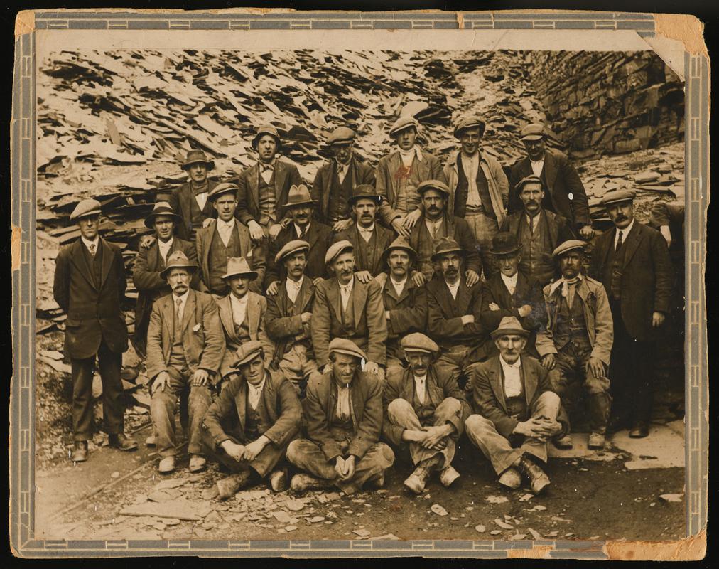 Photograph showing a group of 26 quarrymen at Dinorwic slate quarry, 1924.