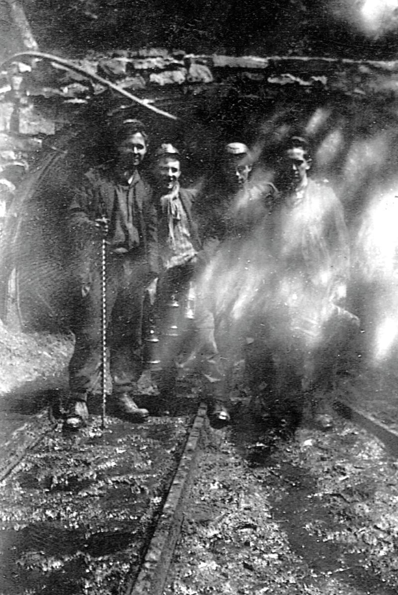 Four Bevin boys at the entrance to the drift at Rhigos Colliery