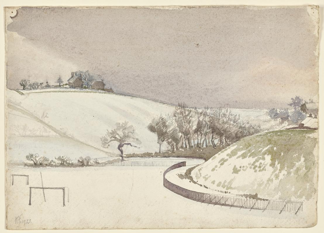Sports field and fenced-off mound under snow
