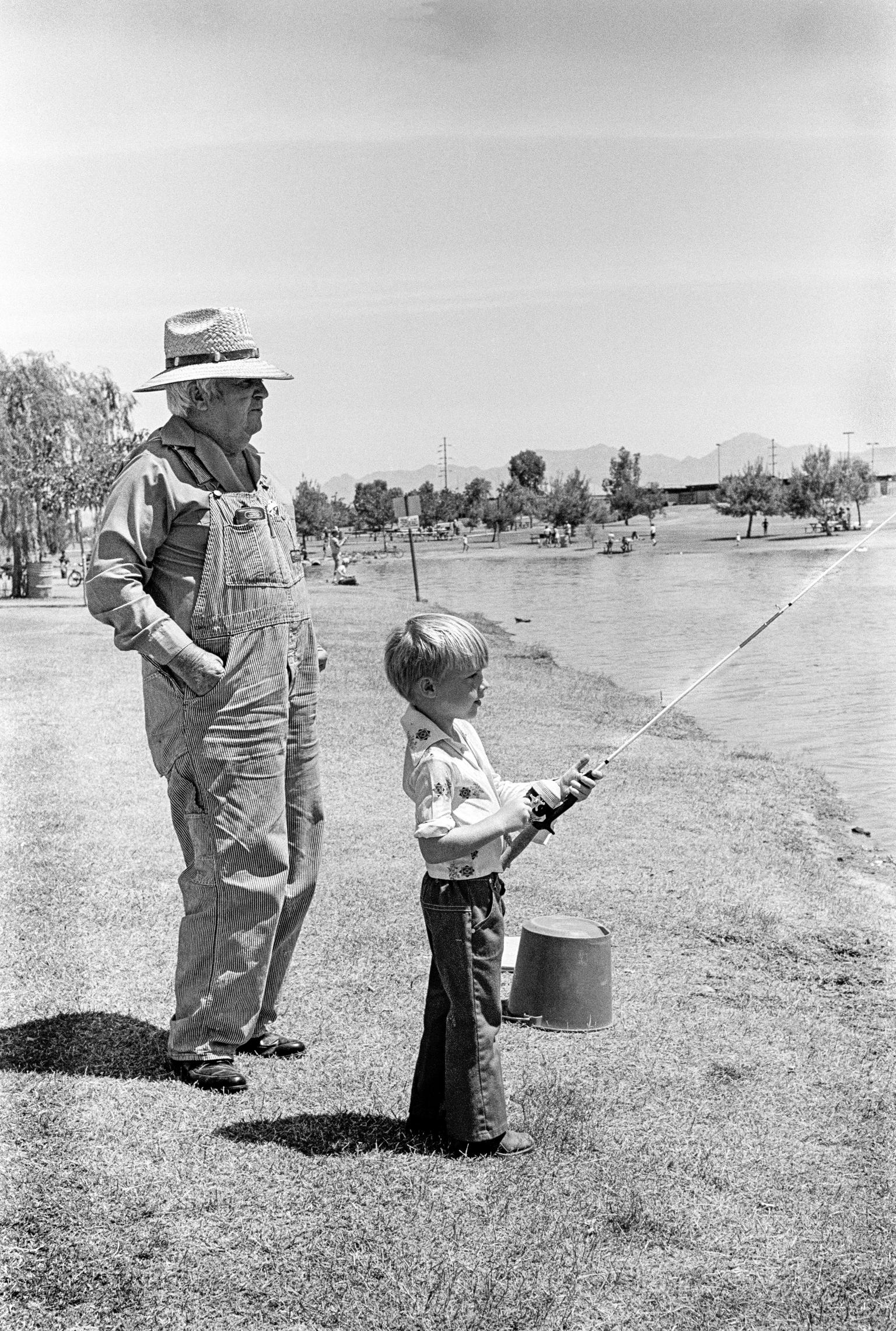 Phoenix Park. Grandad and grandson fishing. Arizona USA