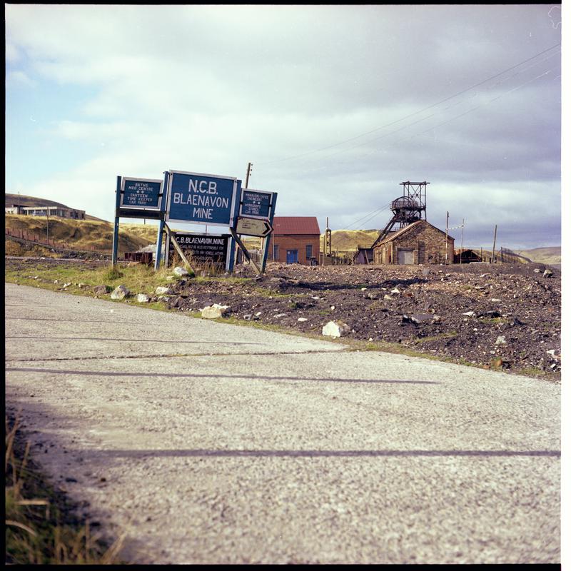 Colour film negative showing an &#039;NCB Blaenavon Mine&#039; sign with headgear in the background.