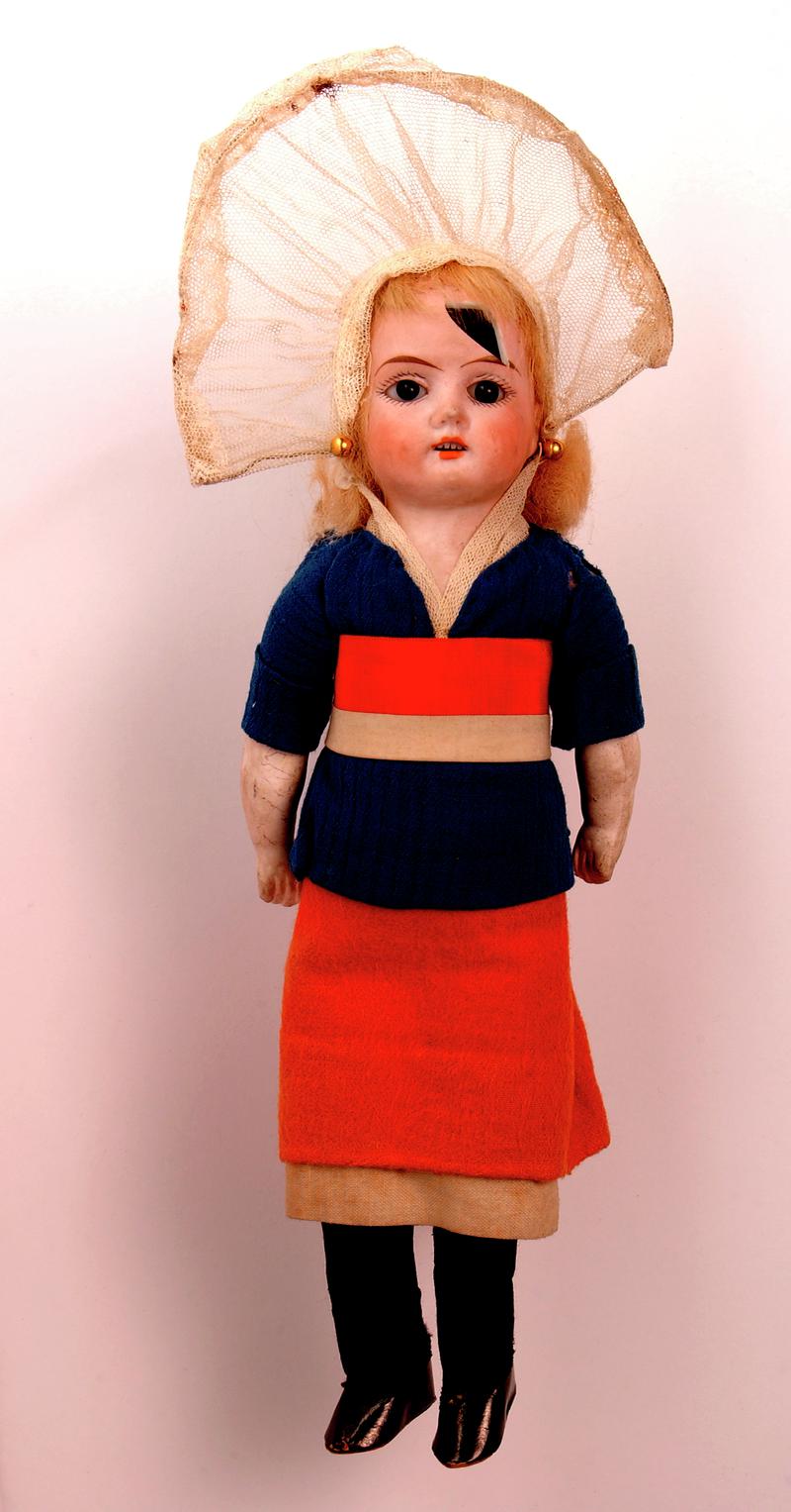 Bisque doll, composition forearms; black glass eyes; blond hair glued to cardboard head cone; torso and legs stuffed with hair dressed in costume of Swiss Canton Valais.