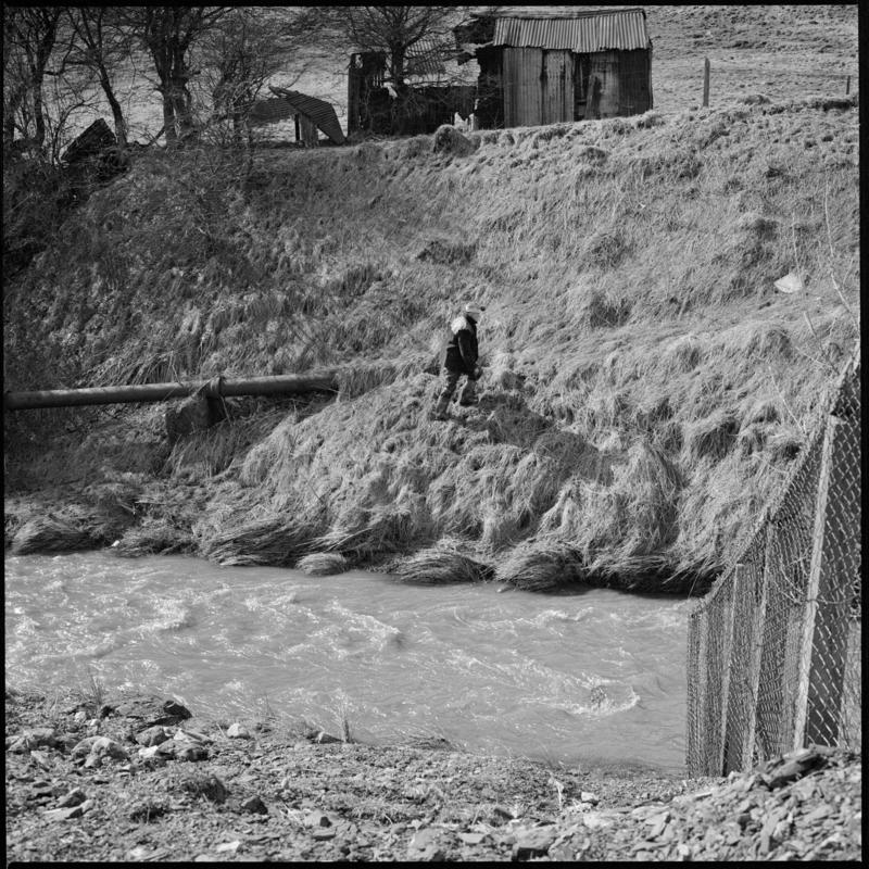 Black and white film negative showing a man walking up a slope, Big Pit Colliery.  &#039;Blaenavon&#039; is transcribed from original negative bag.