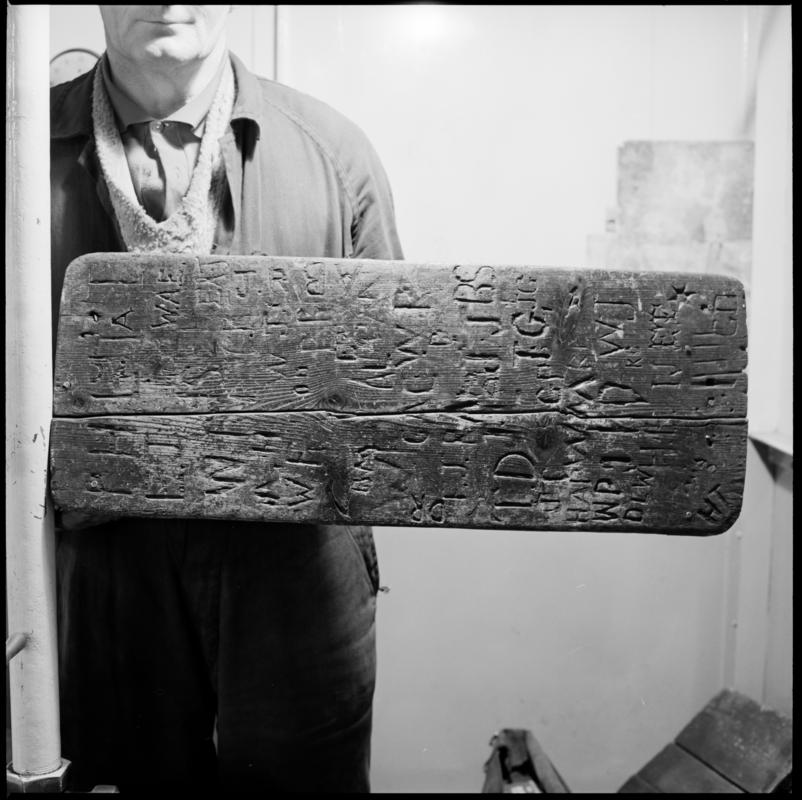 Black and white film negative showing a carved back rest, Big Pit, carved with initials (possibly of winding engine drivers).  &#039;Back Rest Big Pit&#039; is transcribed from original negative bag.