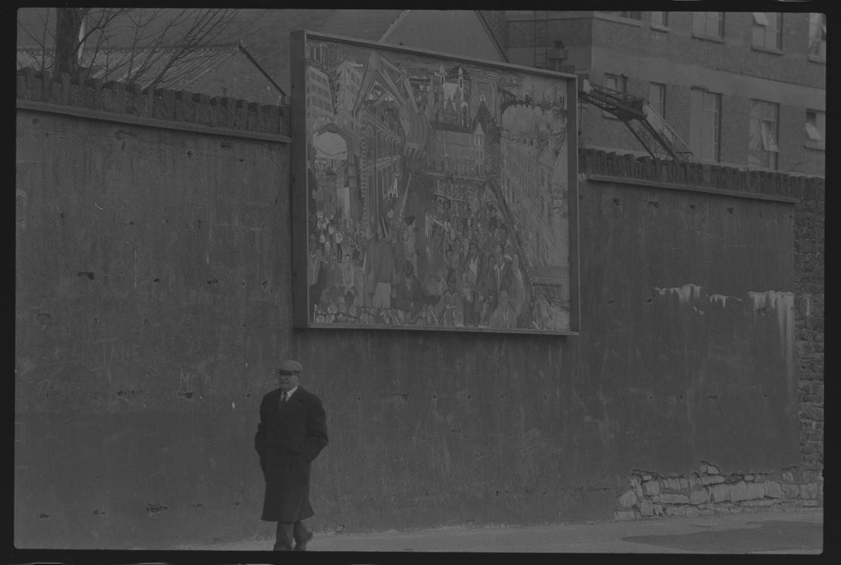 Mural on wall of railway embankment.