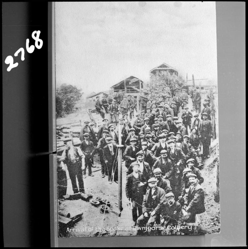 Black and white film negative of a photograph showing a crowd of miners at Cwmgors Colliery.  Caption on the photograph states &#039;arrival of the Spake at Cwmgors Colliery&#039;.