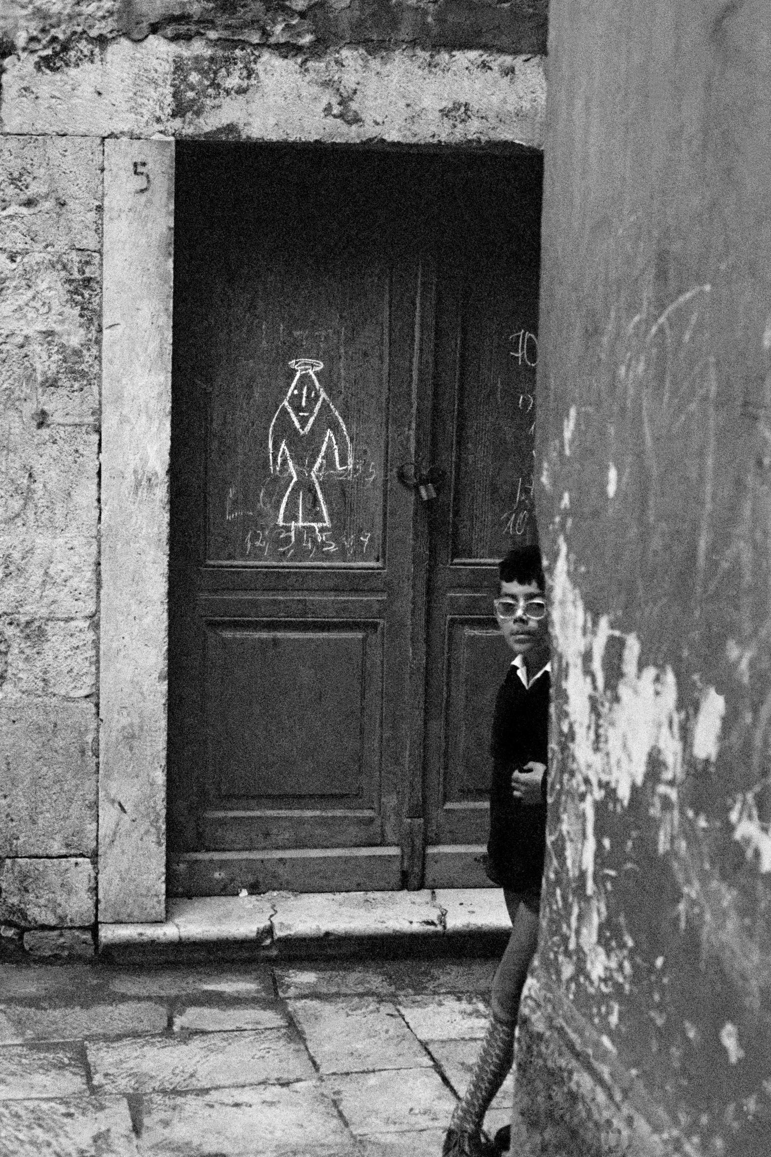 Religious sign and young student. Dubrovnik. Croatia