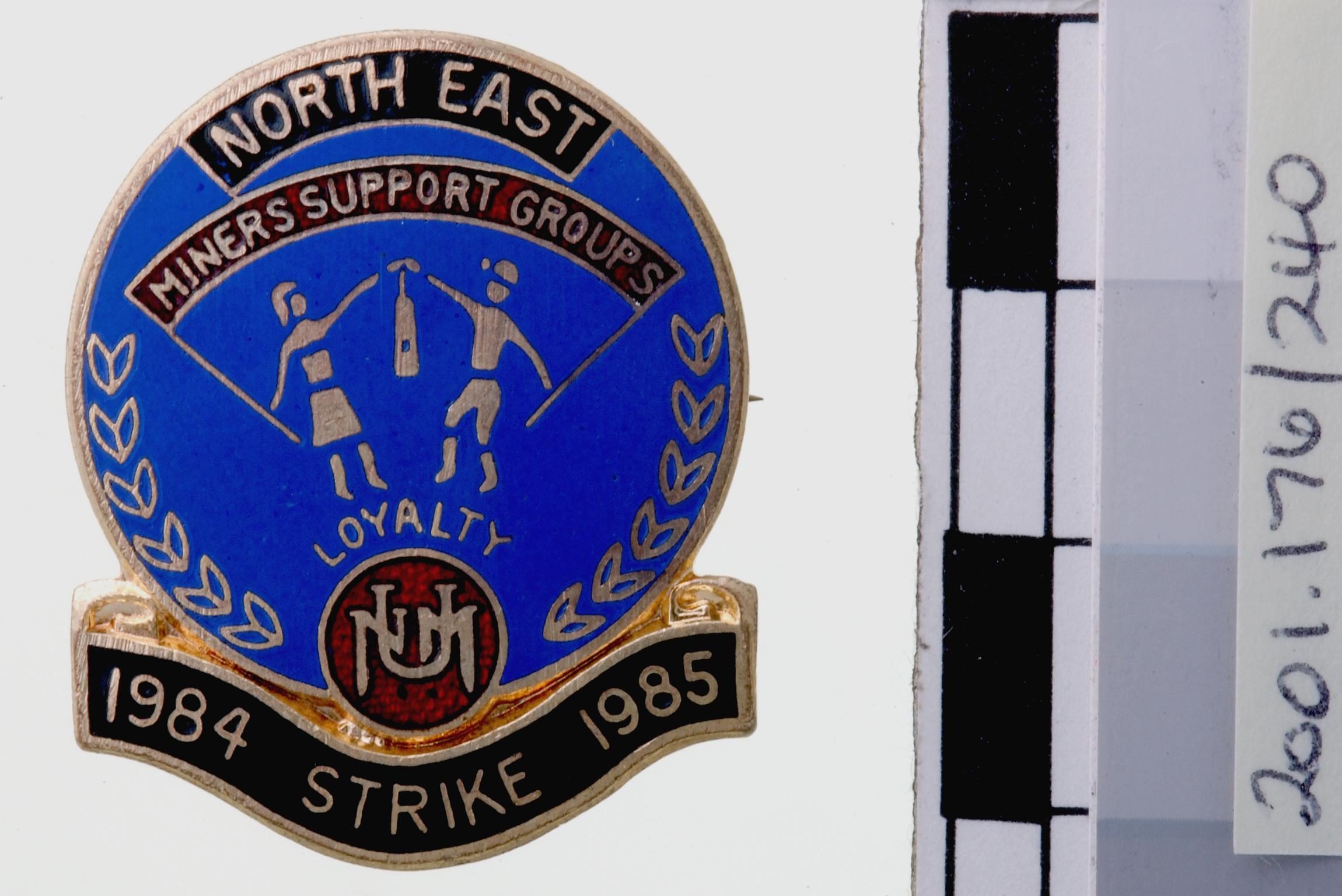 N.U.M. support group, badge