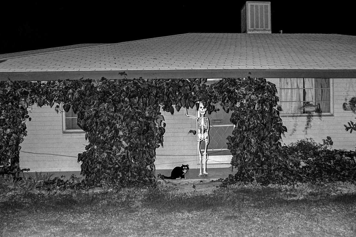 USA. ARIZONA. Tempe. Surreal pair guard a house during Halloween in Tempe, Arizona. 1979.