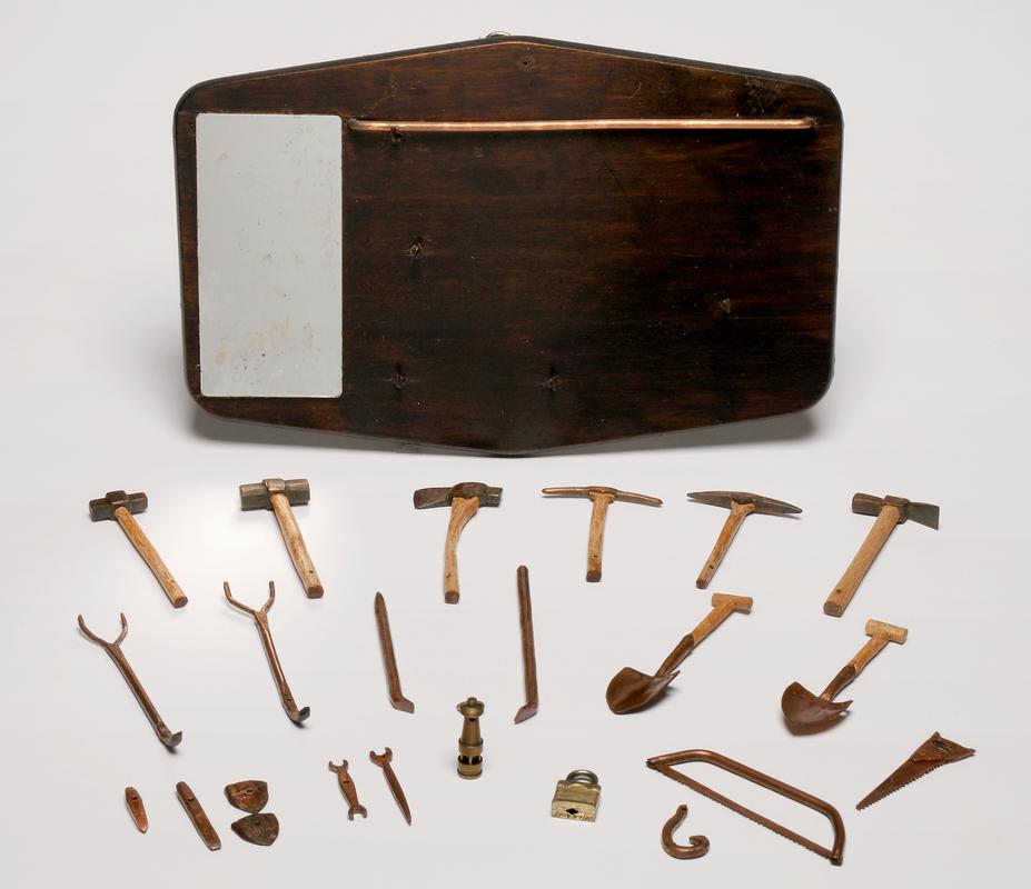 miniature tools on wooden stand