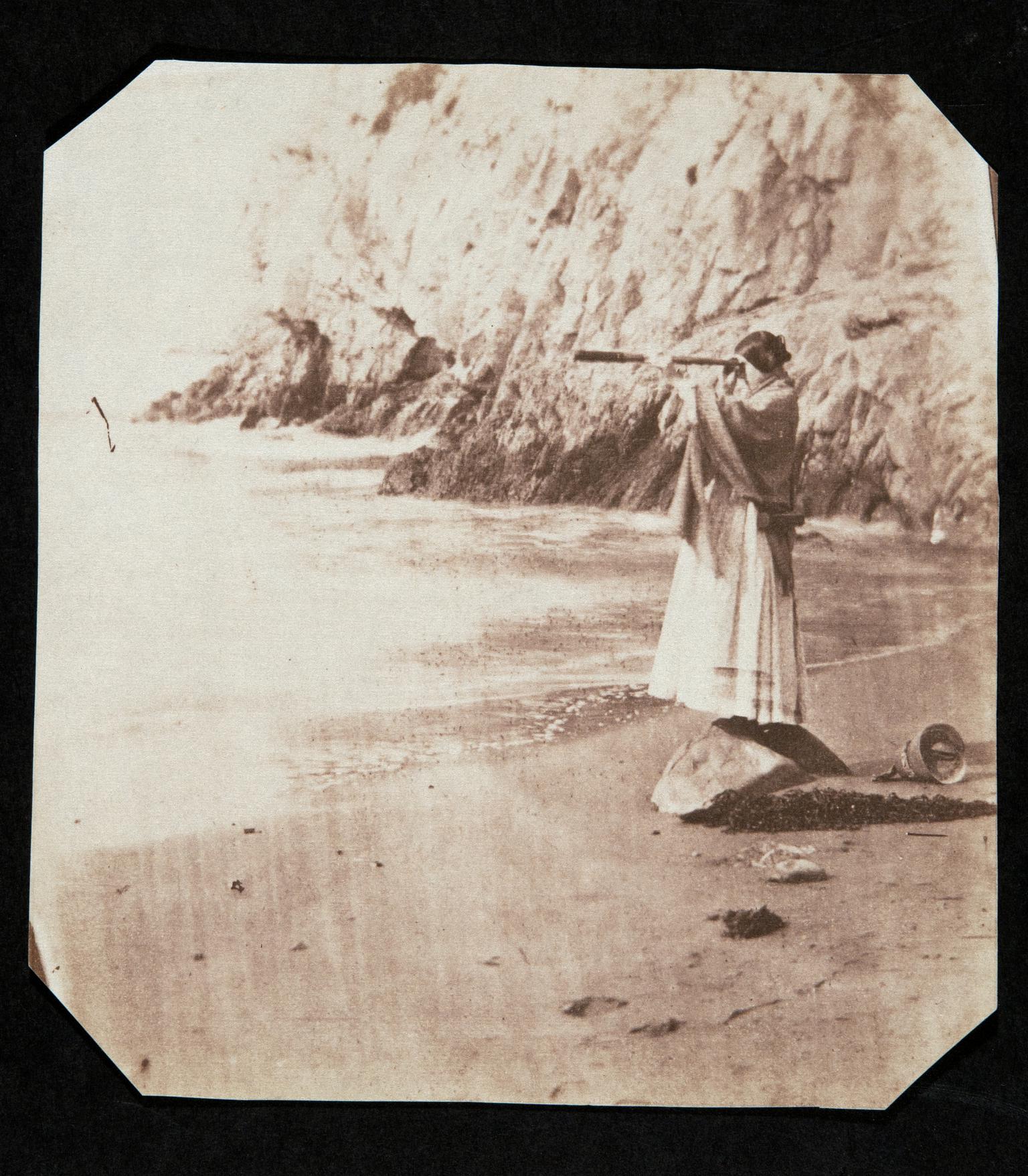 Thereza at Caswell Bay with telescope, photograph