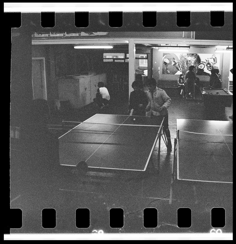 Teenagers playing table tennis at Butetown Youth Club.