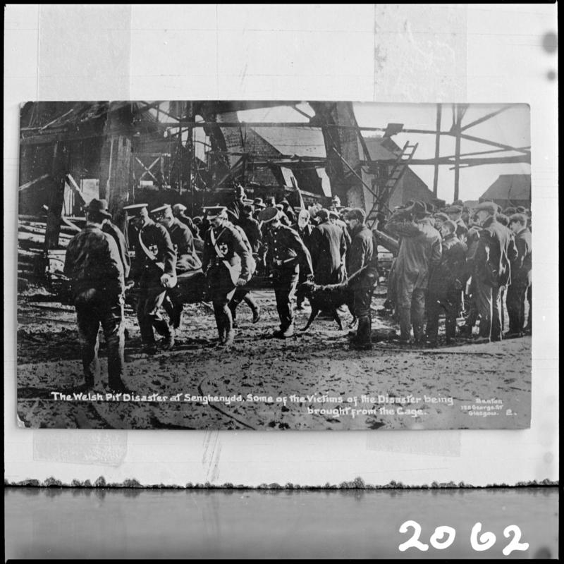 Black and white film negative of a photograph showing the scene at Universal Colliery, Senghenydd after the explosion of 14 October 1913.  Caption on photograph reads &#039;the Welsh Pit disaster at Senghenydd. Some of the victims of the disaster being brought from the cage&#039;.  &#039;Senghenydd&#039; is transcribed from original negative bag.  Appears to be identical to 2009.3/1571.