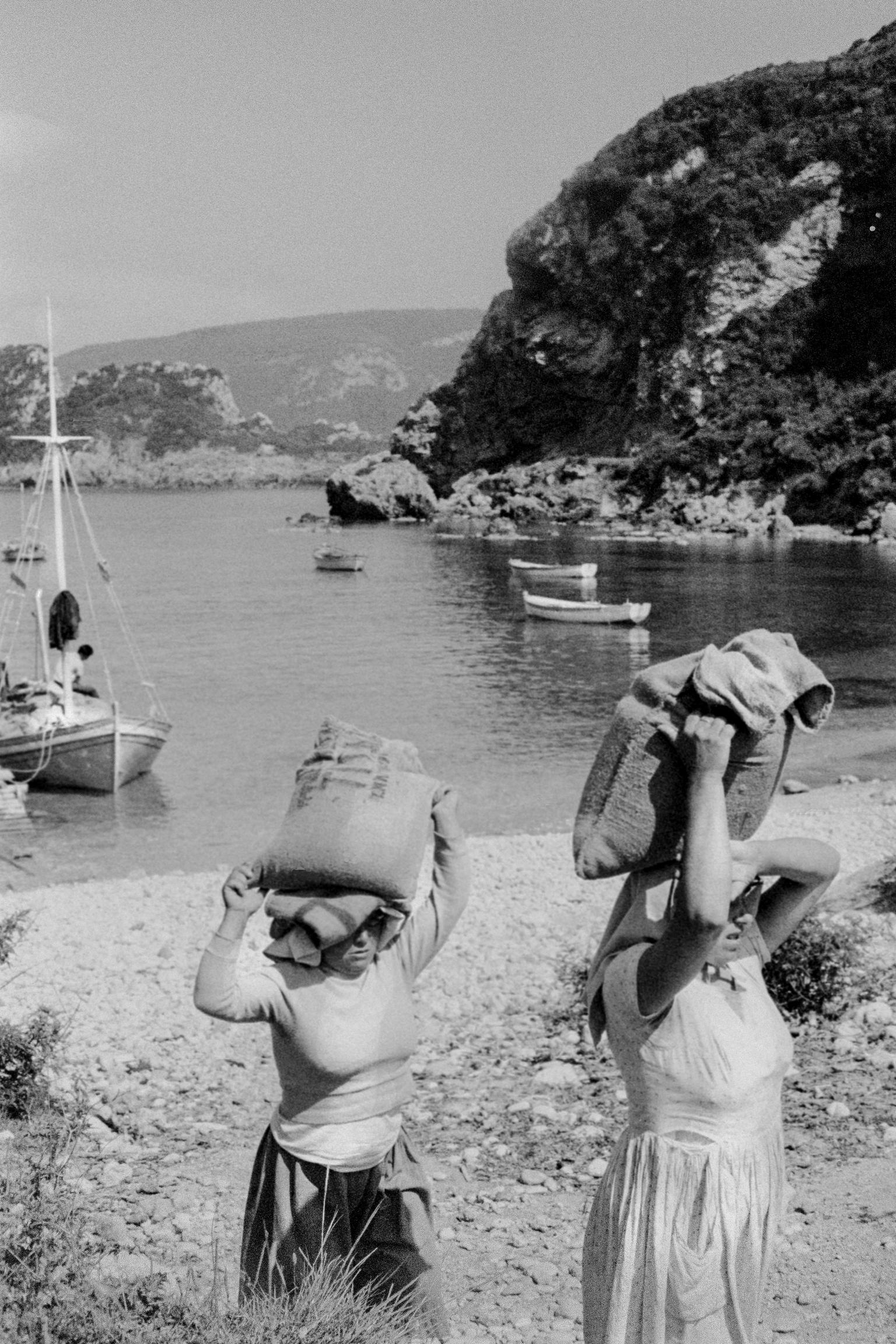 Women unloading boats on the beach. Paleokastritsa. Corfu. Greece