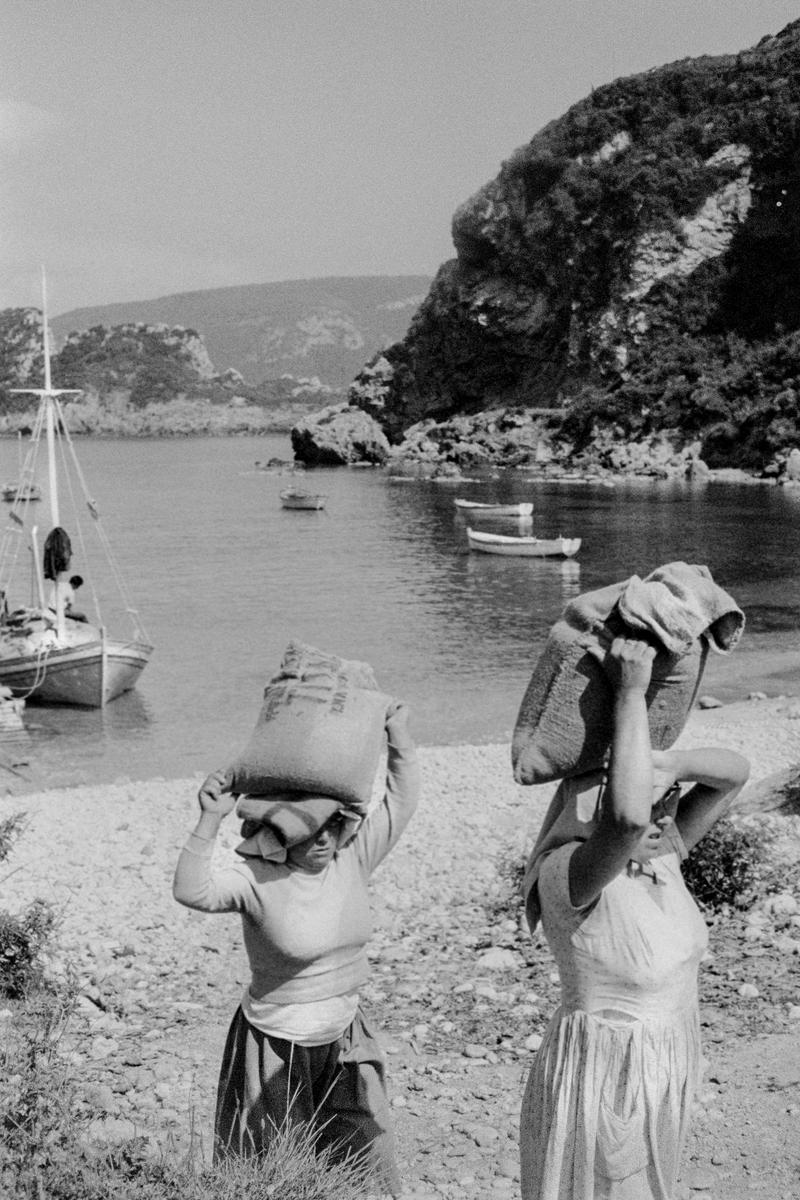 GREECE. Corfu. Paleokastritsa. Women unloading boats on the beach. 1964.