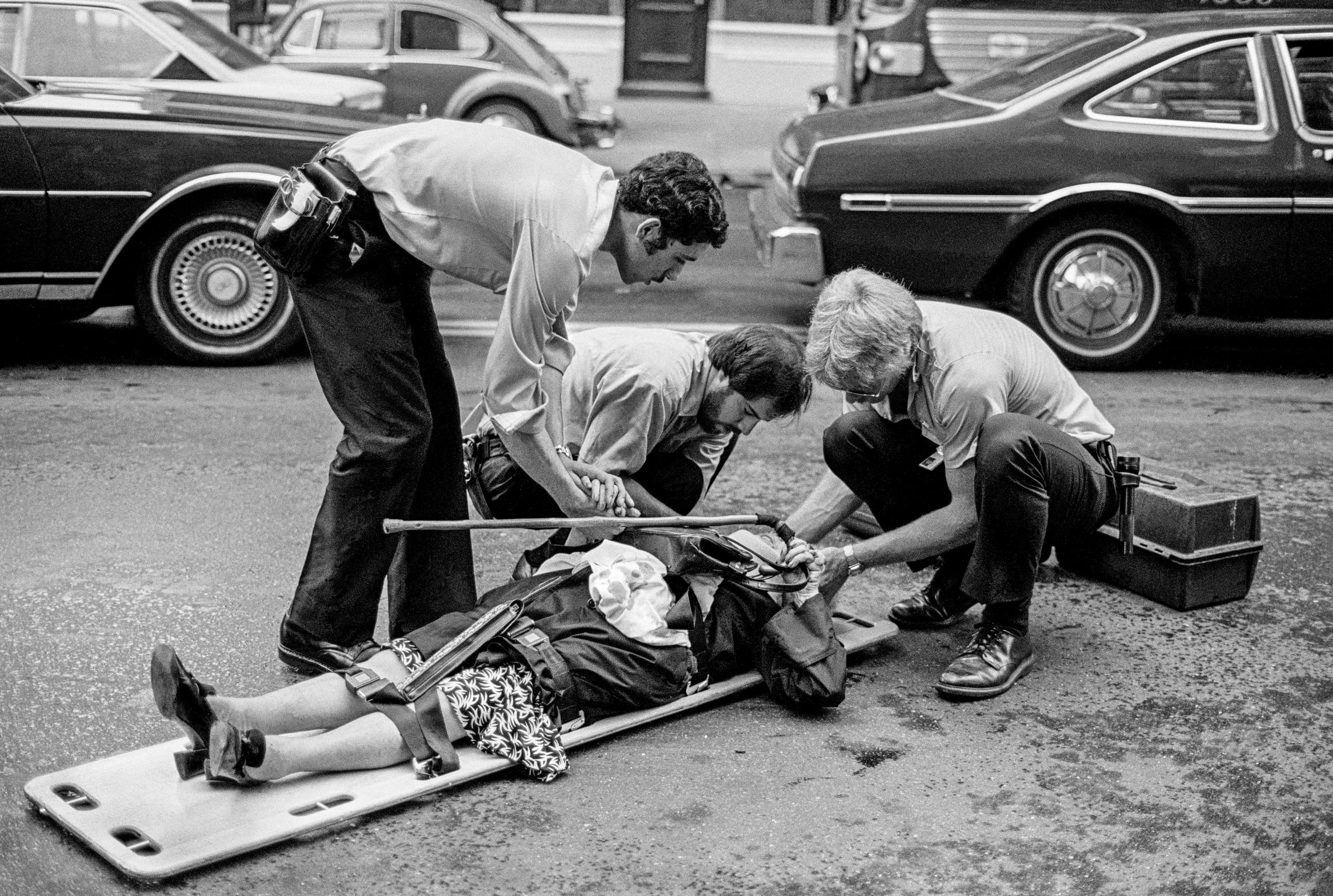 Street casualty. Accident or simply a fall. Ambulance personnel oversee. New York, USA