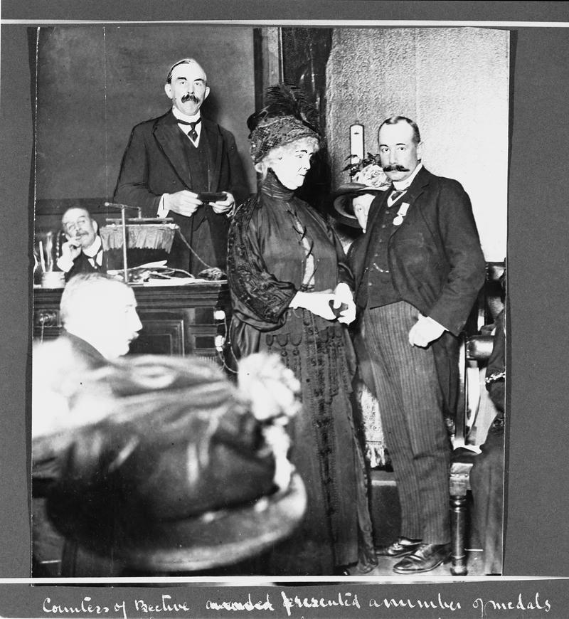 Countess of Bective presenting a medal to Mine Manager, Mr Llewelyn. The Countess presented a number of medals awarded by the R.S.P.C.A to officials of the Glamorgan Collieries for heroism in rescuing pit ponies during Tonypandy Strike Riots