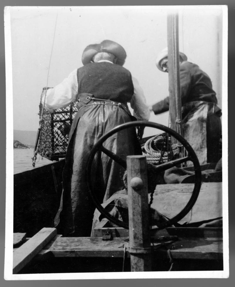 Samuel Jenkins, Aberporth, bringing a lobster pot on board his fishing vessel