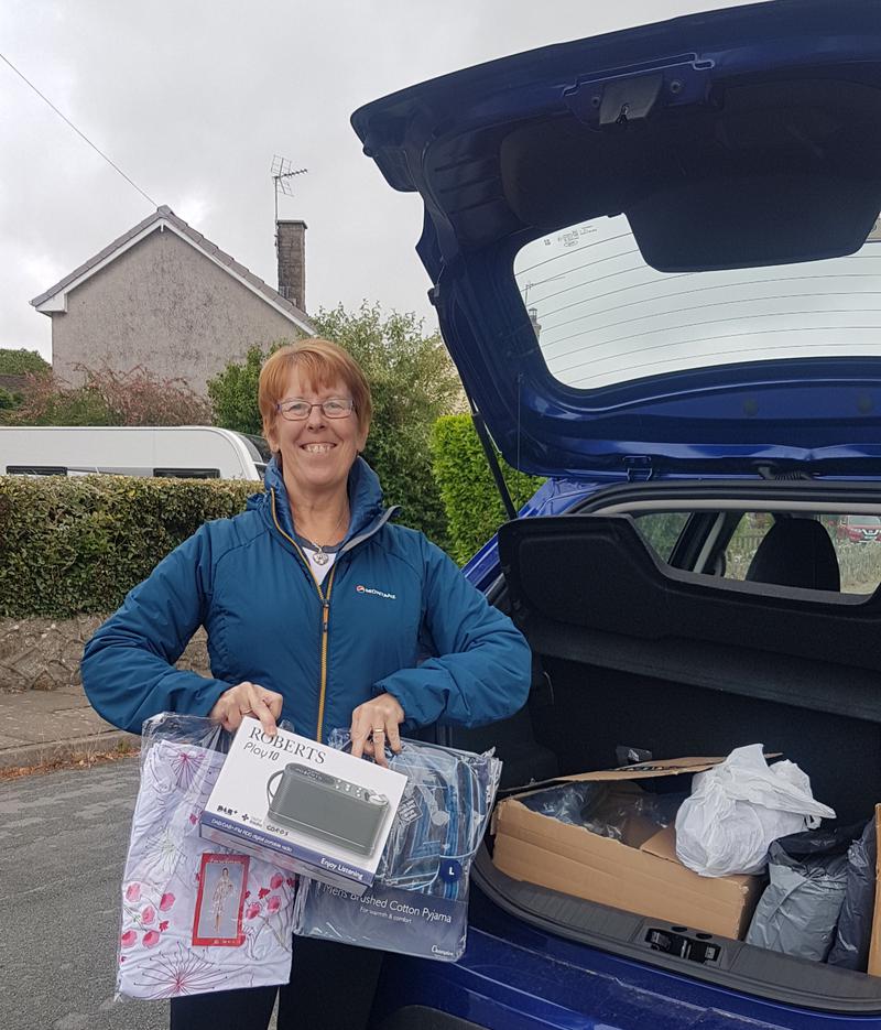 Ward manager and senior nurse Sue Baldry collects radios, and nightwear donated to Covid ward, Princess of Wales, Bridgend by Masks and Sundries Llanmaes.