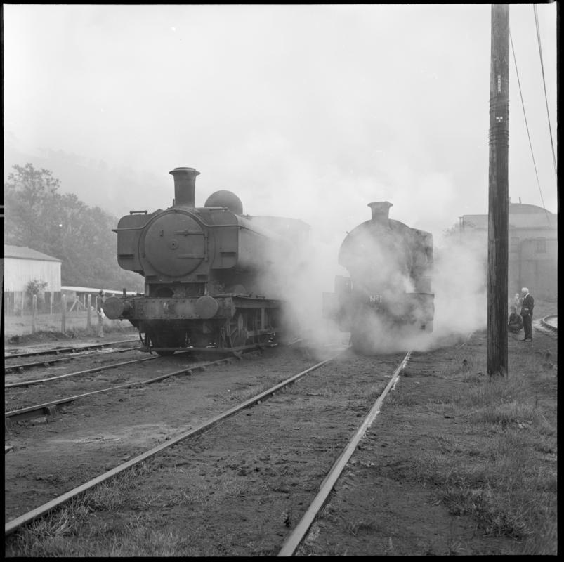 Black and white film negative showing locomotives at a locomotive shed, Mountain Ash.
