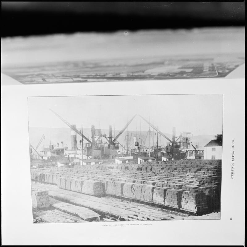 Black and white film negative showing fuel ready for shipment at Swansea Docks, photographed from a publication.