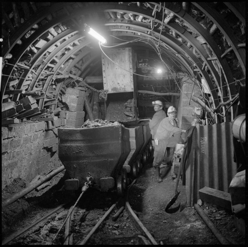 Black and white film negative showing an underground transfer point, Ammanford Colliery 7 September 1976.  &#039;Ammanford 7 Sep 1976&#039; is transcribed from original negative bag.