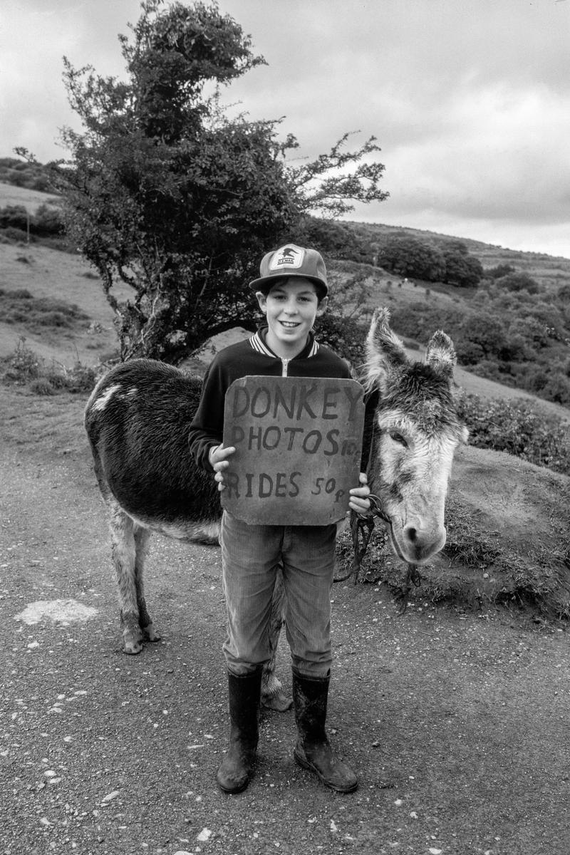 IRELAND. Lisdonvarna. Fergal Connolly with Donkey Charlie. Fergal is 12 his donkey 15. On average they make £15 a day. He invests his money in buying Calves, so far he has bought two, each for about £190. In 18 months he expects to sell them for £600 each. 1984.