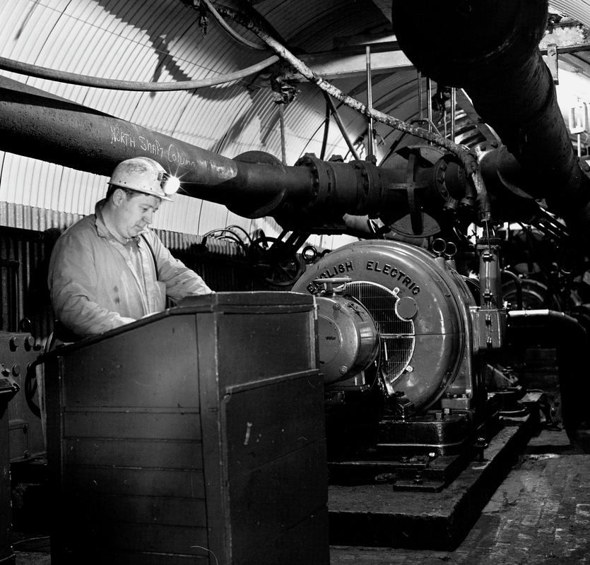 Black and white film negative showing a man operating the &#039;English Electric&#039; engine, Oakdale Colliery, May 1980.  &#039;Oakdale May 1980&#039; is transcribed from original negative bag.