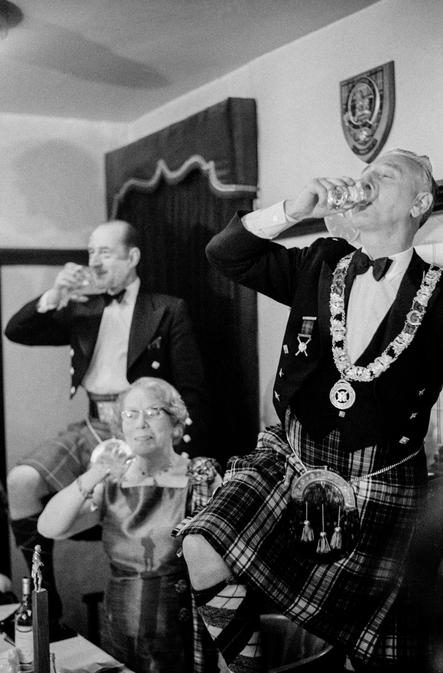 Drinking the toast to Robert Burns on Burns night. Full tartan is the dress of the evening. Edinburgh. Scotland