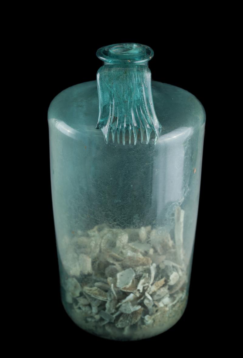 Roman glass bottle with human bones