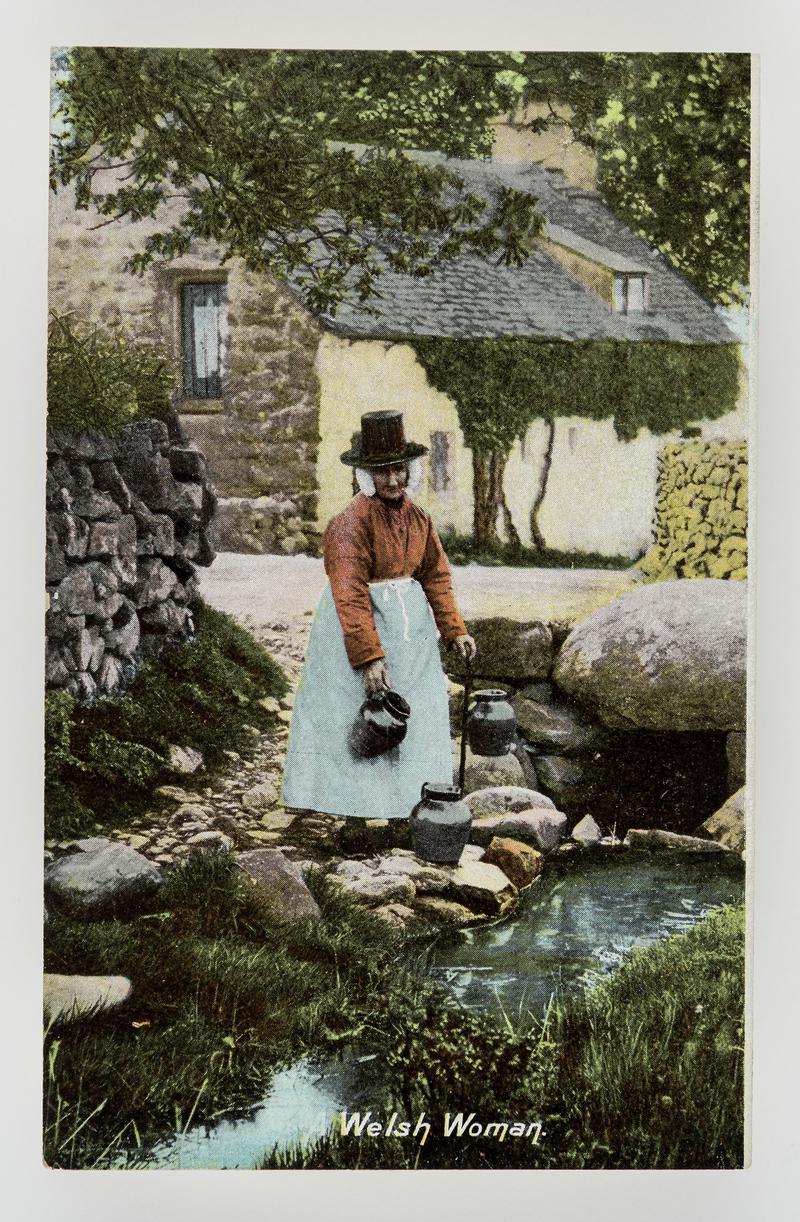 A Welsh woman fetching water from stream in pitchers.