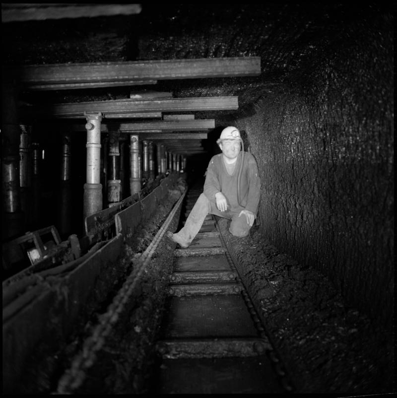 Black and white film negative of a photograph showing a man beside props and bars underground at Celynen South, Colliery 19 July 1976.  &#039;South Celynen 19/7/1976&#039; is transcribed from original negative bag.