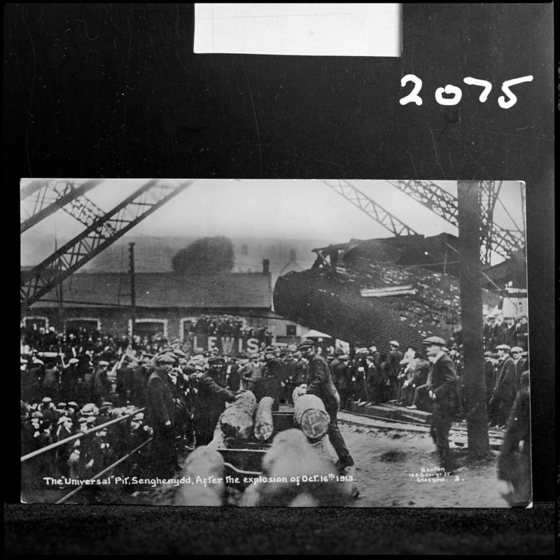 Black and white film negative of a photograph showing the scene at Universal Colliery, Senghenydd after the explosion of 14 October 1913.  Caption on photograph reads &#039;the Universal Pit, Senghenydd.  After the explosion of Oct 14th 1913.