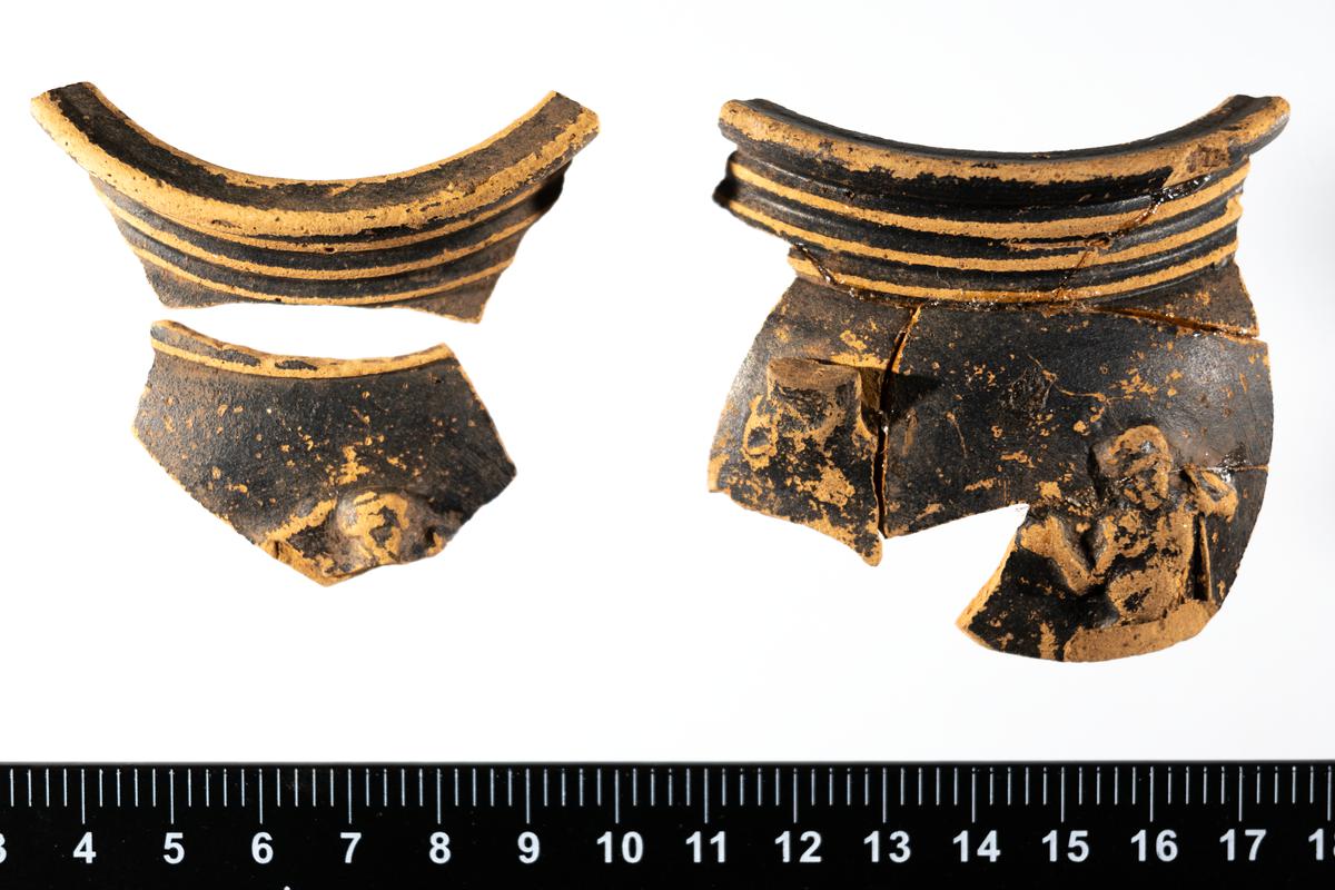 Bowl sherds showing a figure - satyr or silenus. Described as &#039;black samian&#039;.