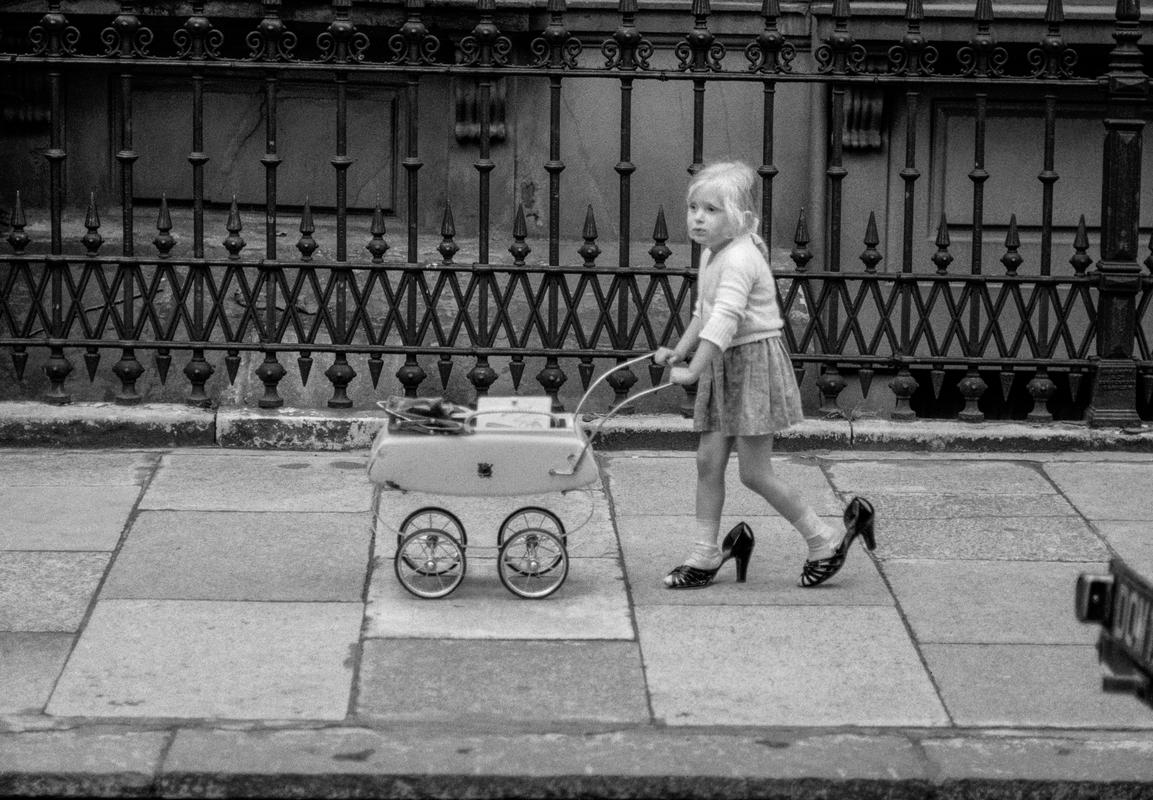 GB. ENGLAND. Nottinghill Gate. Dreaming of being mum. Taken on a Contax 2 camera (first professional camera). 1958.