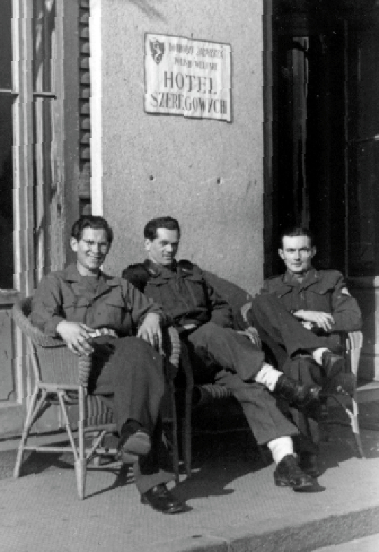 3 soldiers relaxing in front of hotel