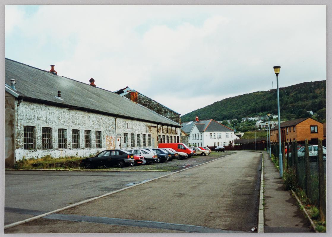 Pontardawe tinplate works, Pontardawe, showing assorting room south façade with gable end of tinhouse beyond, and the main west façade of Gilbertson &amp; Co&#039;s general offices in background on Ynysderw Road, October 1994.