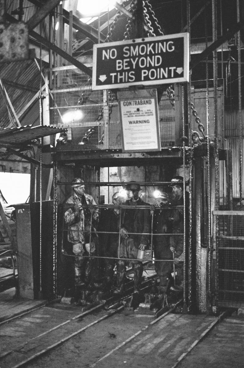 Men emerging from cage, Big Pit
