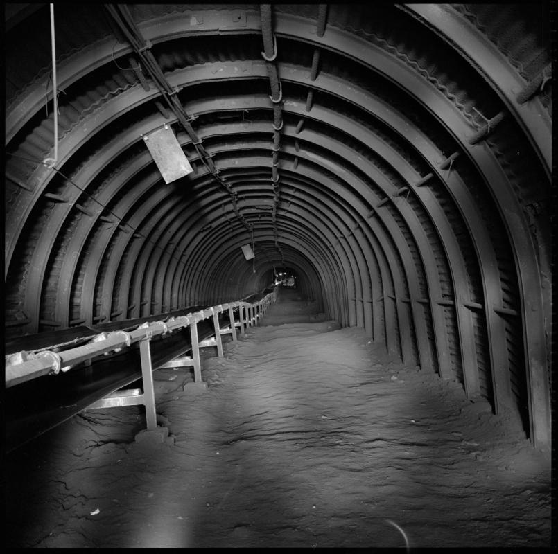 Black and white film negative showing a roadway and conveyor belt, Cwmgwili Colliery.  &#039;Cwmgwili&#039; is transcribed from original negative bag.