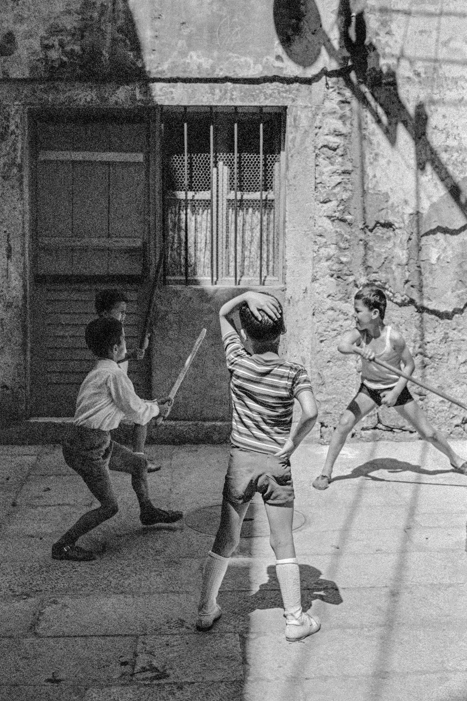 Children playing violent games in the streets. Dubrovnik. Croatia