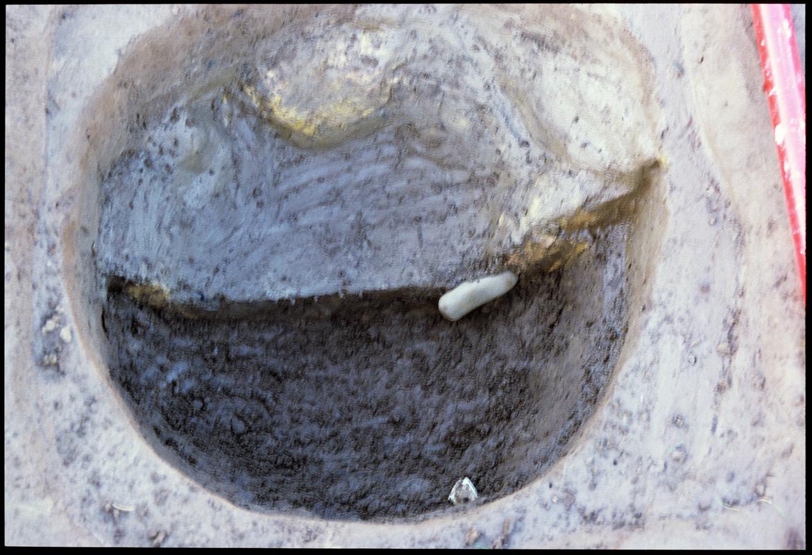 Burry Holms, Gower. 2001 Trench 4. Clay lined pit 127 with half the clay removed revealing a hammerstone and blade core. Looking west.