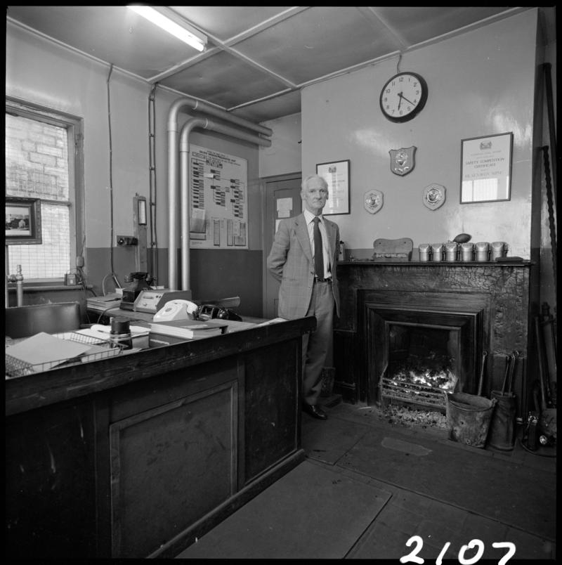 Black and white film negative showing Glyn Morgan, the final NCB manager, in his office at Big Pit Colliery, 28 November 1980.  &#039;Blaenavon 28/11/80 Glyn Morgan&#039; is transcribed from original negative bag.