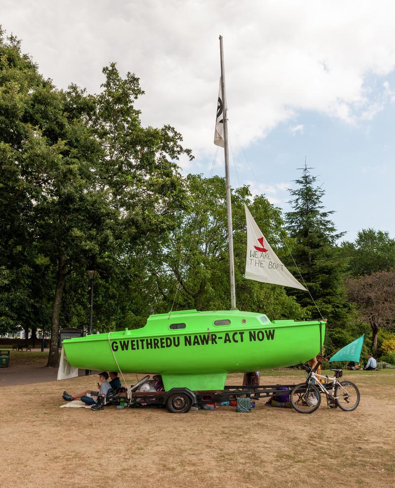 Extinction Rebellion Protest in Cardiff - Civic Centre, Museum and City Hall Lawn. Green Yachts with Protest Slogans painted on them.