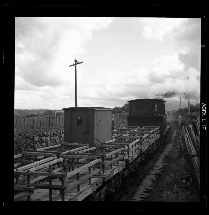 &#039;Run&#039; of empty slate wagons on transporter wagons - showing the Guard&#039;s Van, Padarn Railway, 1958-60.