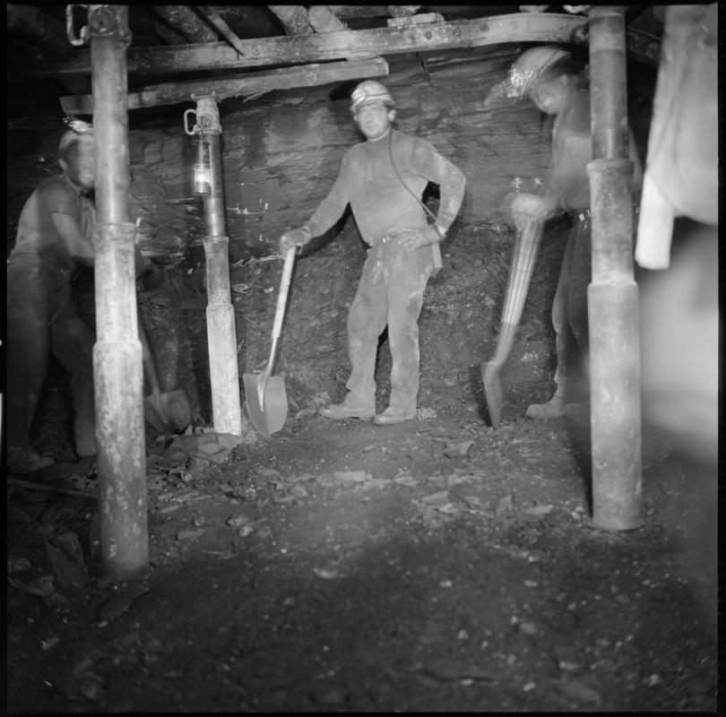 Black and white film negative showing miners at work, Six Bells Colliery.