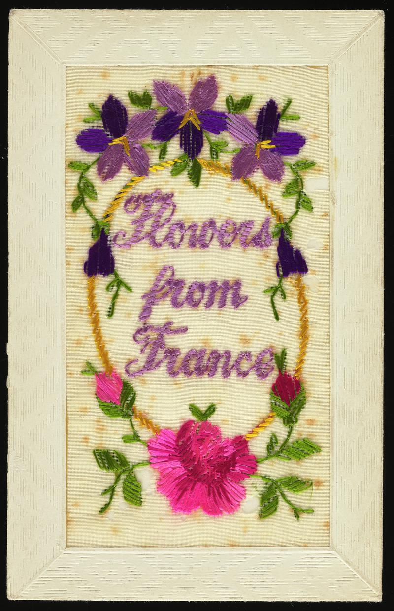 Embroidered silk postcard inscribed Flower From France. Sent from France by Gordon Hobbs to his sister during First World War. Dated Aug 22nd 1917. Embroidered with three violets above and roses below. Message on back.
